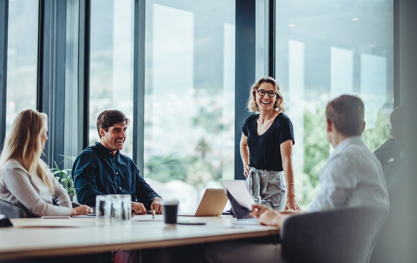 Leaders collaborating in a glass-walled meeting room